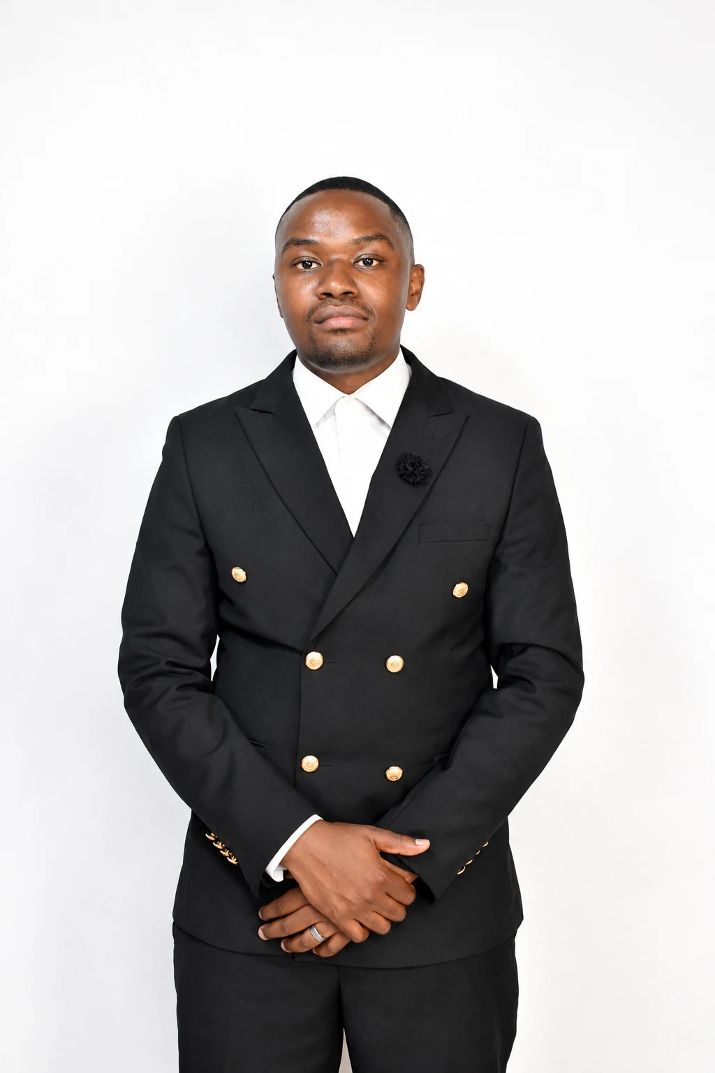 Ishmael Mbongwana in a black double-breasted suit